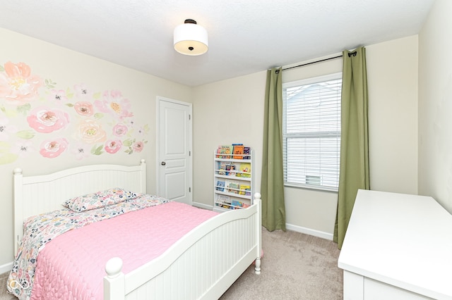 bedroom featuring light carpet and baseboards