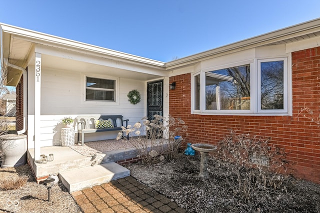 property entrance featuring brick siding