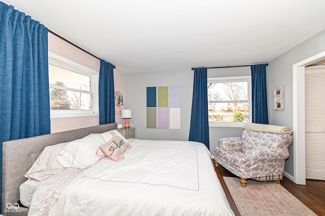 bedroom featuring baseboards and wood finished floors