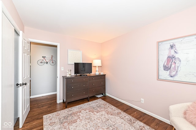 interior space with dark wood-style flooring and baseboards