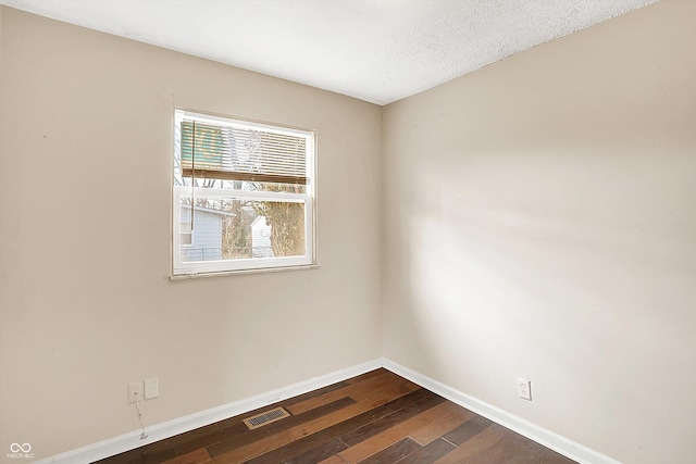 empty room featuring dark wood-type flooring