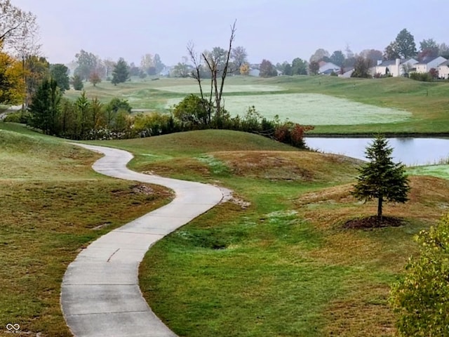 surrounding community with a lawn and a water view