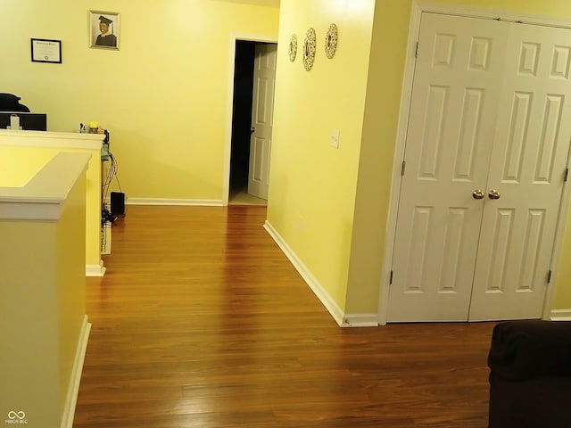 hallway with hardwood / wood-style floors