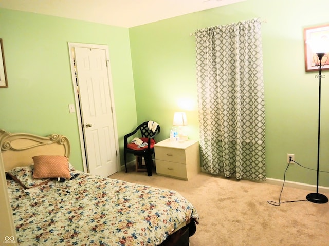 bedroom featuring light carpet