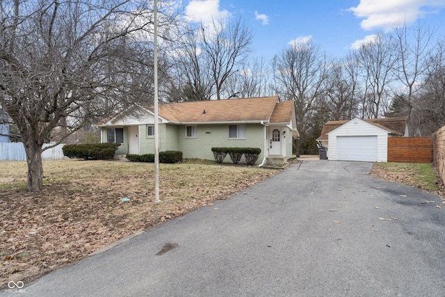 ranch-style home with an outbuilding and a garage