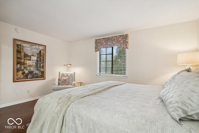 bedroom with dark hardwood / wood-style floors