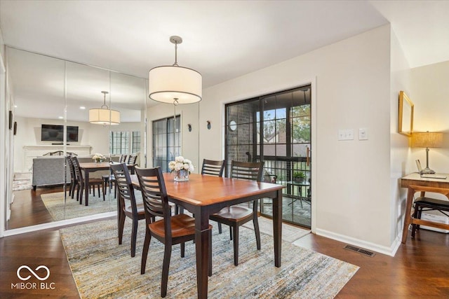 dining room with dark wood-type flooring