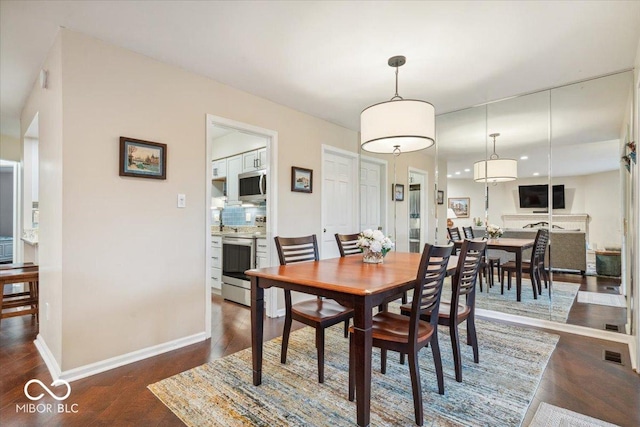 dining area featuring dark hardwood / wood-style flooring