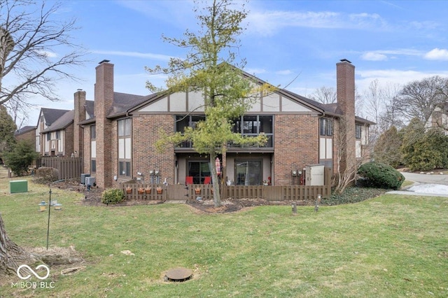 rear view of property featuring a lawn