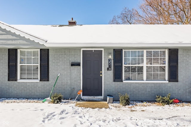 view of snow covered property entrance