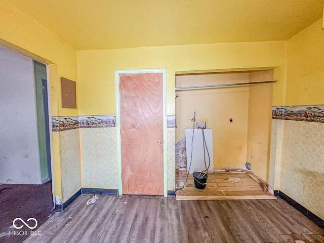 unfurnished bedroom featuring hardwood / wood-style flooring and electric panel