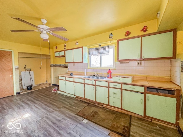 kitchen with tasteful backsplash, sink, ceiling fan, and light wood-type flooring