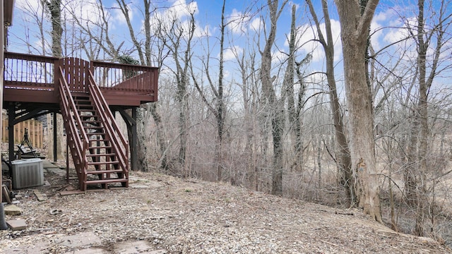 view of yard featuring stairway, cooling unit, and a wooden deck