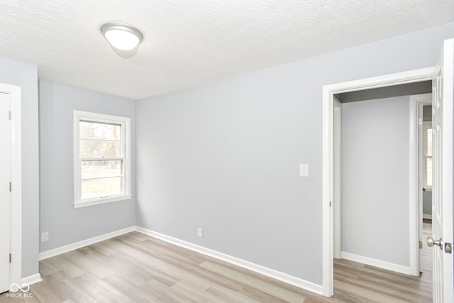 unfurnished bedroom featuring light hardwood / wood-style flooring and a textured ceiling