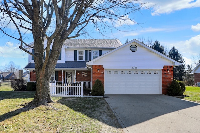 view of property featuring a garage and a front yard