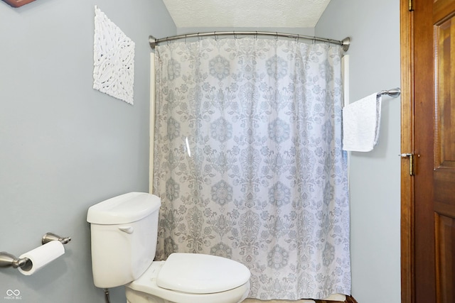 bathroom featuring a textured ceiling and toilet