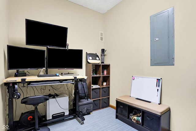 home office featuring electric panel and light hardwood / wood-style flooring