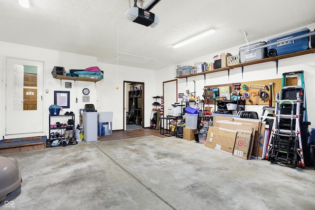 garage featuring a garage door opener and a workshop area