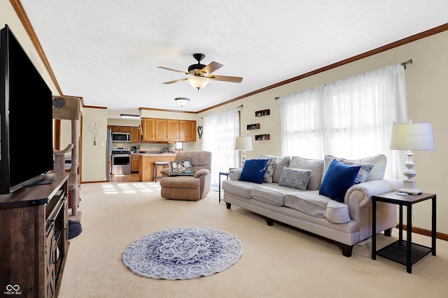 living room with ceiling fan, light colored carpet, ornamental molding, and a textured ceiling