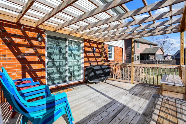 deck featuring grilling area and a pergola