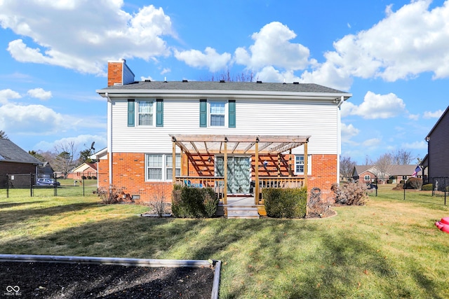 rear view of property with a wooden deck, a yard, and a pergola