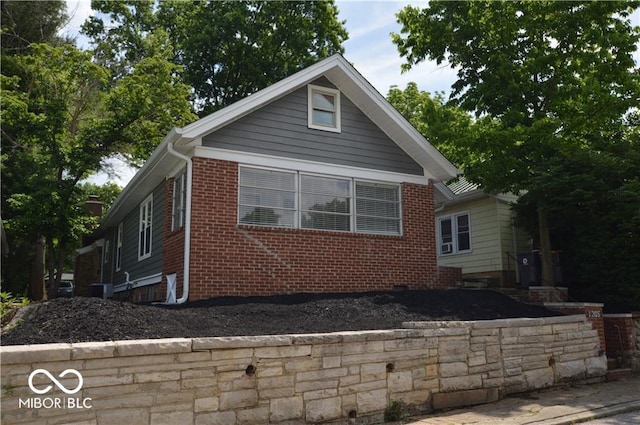 view of property exterior featuring brick siding