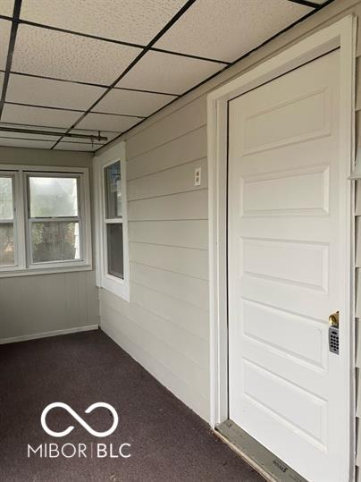 unfurnished sunroom featuring a paneled ceiling