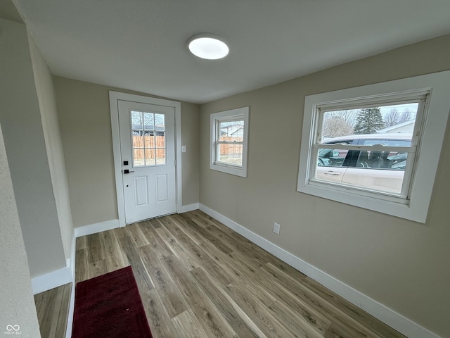 doorway to outside with light wood-type flooring