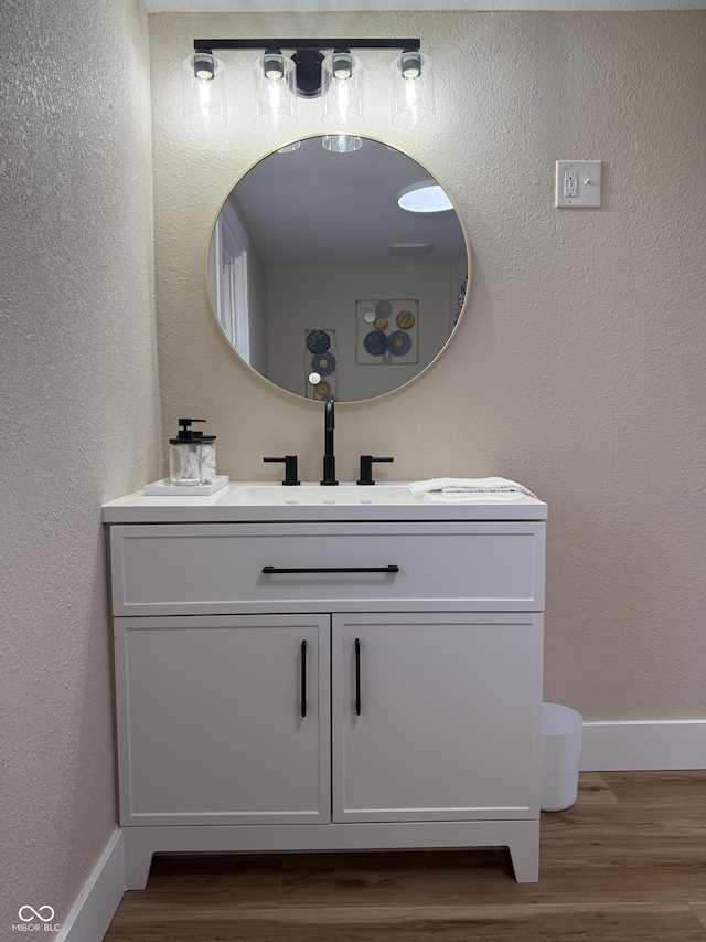 bathroom with vanity and wood-type flooring