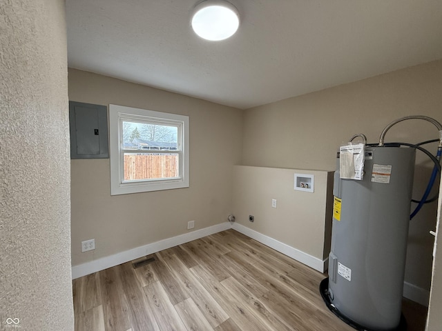 washroom featuring electric dryer hookup, electric panel, electric water heater, washer hookup, and light wood-type flooring