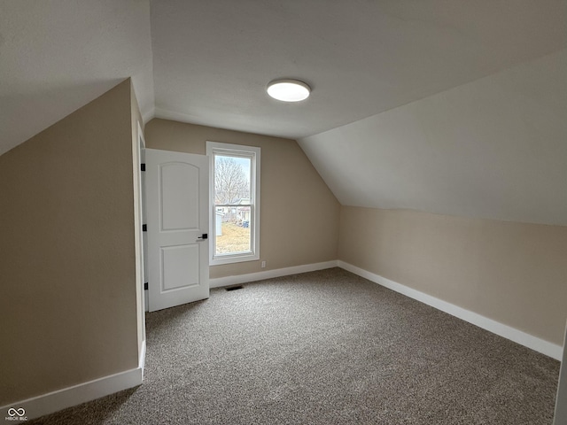 bonus room featuring vaulted ceiling and carpet floors