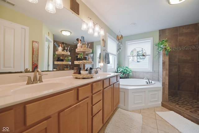 bathroom featuring tile patterned flooring, vanity, and shower with separate bathtub