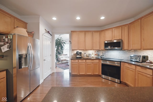 kitchen with ornamental molding, stainless steel appliances, light hardwood / wood-style floors, and decorative backsplash