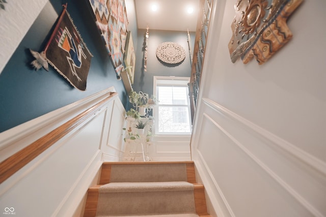 staircase with hardwood / wood-style floors