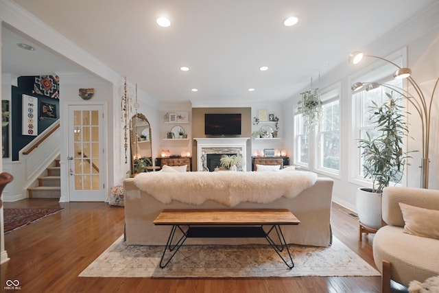 living room featuring crown molding and wood-type flooring