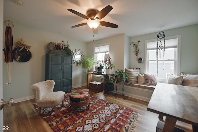 sitting room with ceiling fan and light hardwood / wood-style flooring