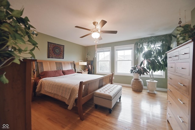 bedroom with ceiling fan and light hardwood / wood-style floors