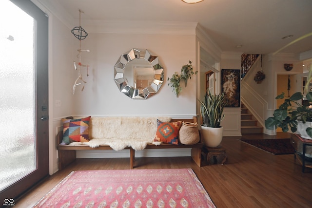 living area with crown molding and wood-type flooring