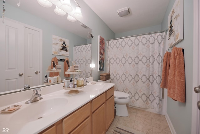 bathroom featuring tile patterned flooring, vanity, and toilet