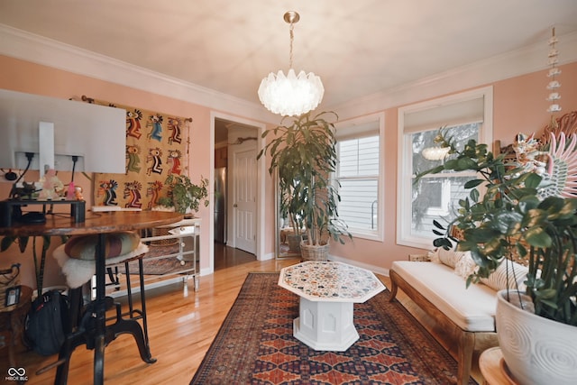 interior space featuring crown molding, an inviting chandelier, and light hardwood / wood-style floors