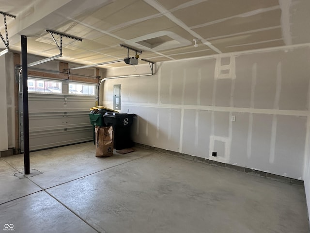 garage with a garage door opener and electric panel