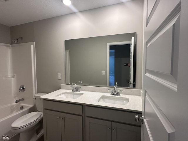 full bathroom featuring vanity, bathtub / shower combination, and toilet