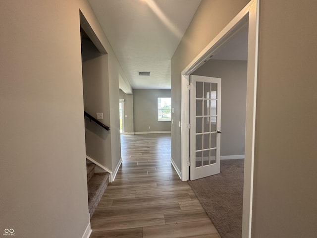 hallway with wood-type flooring