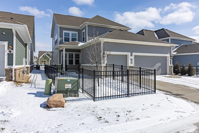 view of front facade featuring fence, driveway, and a garage