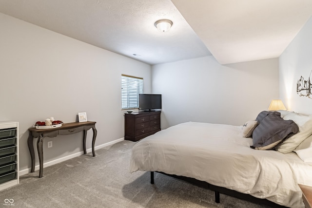 carpeted bedroom featuring baseboards