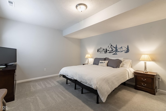 bedroom with light colored carpet, visible vents, and baseboards