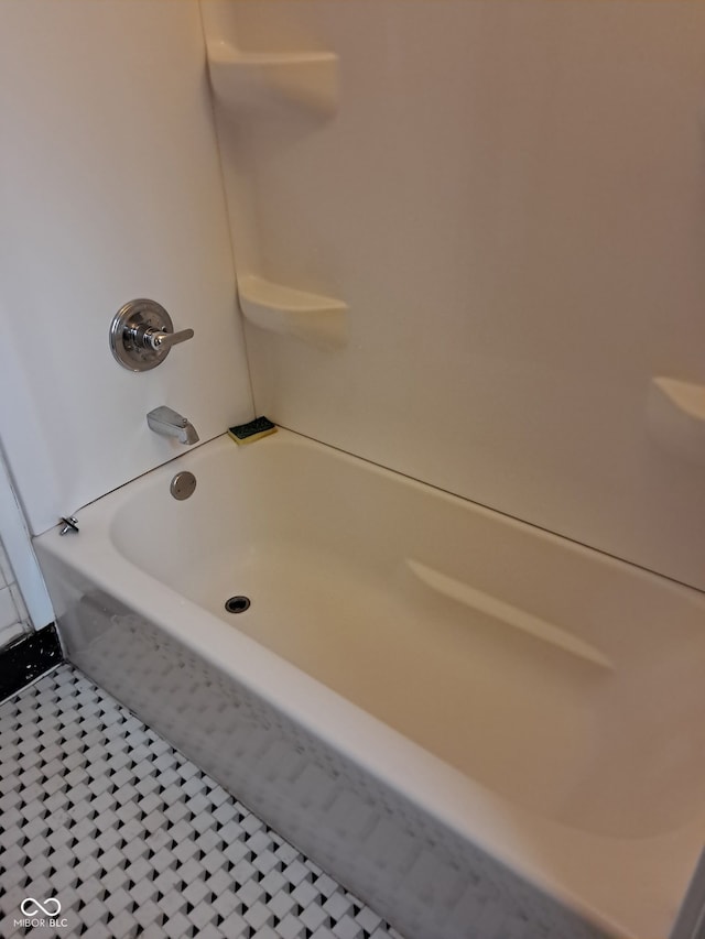 bathroom featuring tile patterned flooring and tub / shower combination