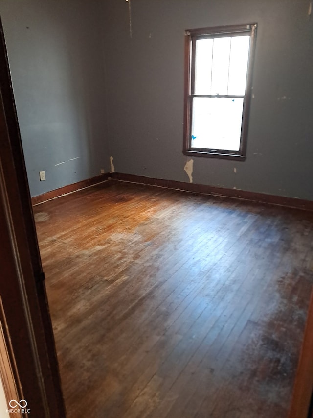 empty room with dark hardwood / wood-style floors