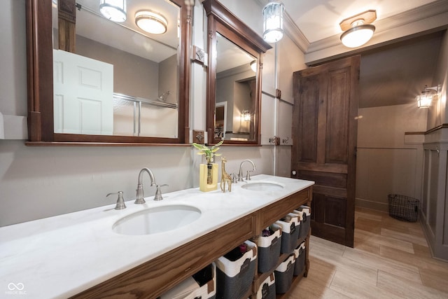 bathroom featuring crown molding and vanity