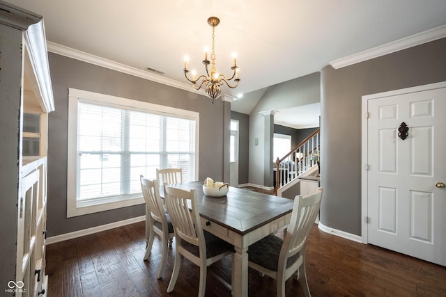 dining room with an inviting chandelier, dark wood-type flooring, ornamental molding, and lofted ceiling